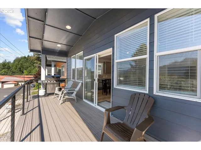 a balcony with furniture and a potted plant
