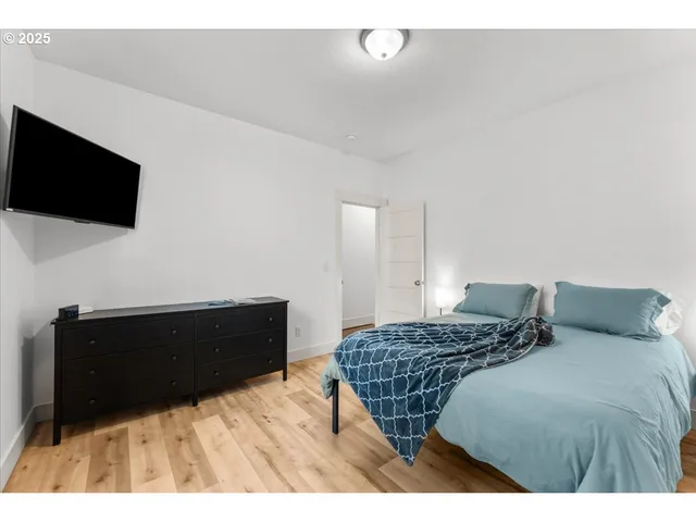 a bedroom with a bed and a television