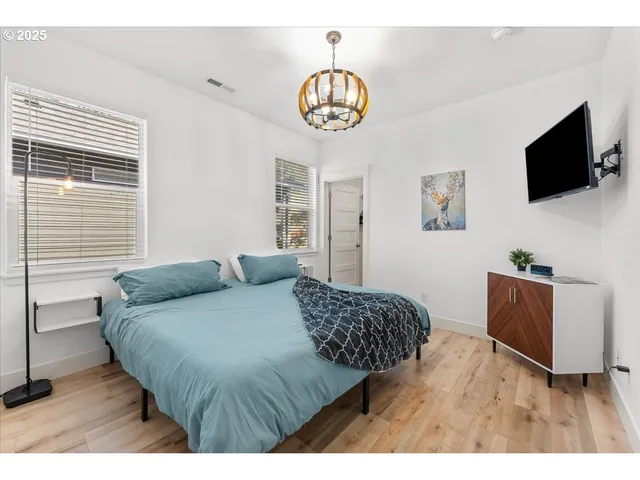 a bedroom with a bed and a flat screen tv
