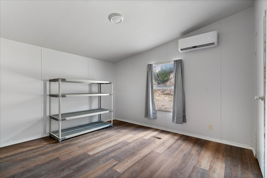10500 Tarantula Court Leander, TX 78641 - Photo 16 of 34 an empty room with wooden floor and window