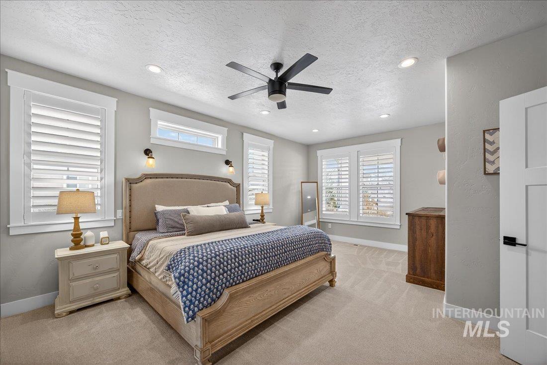 15111 Pinehurst Way Caldwell, ID 83607 - Photo 11 of 43 Bedroom with a textured ceiling, a ceiling fan, light colored carpet, and recessed lighting