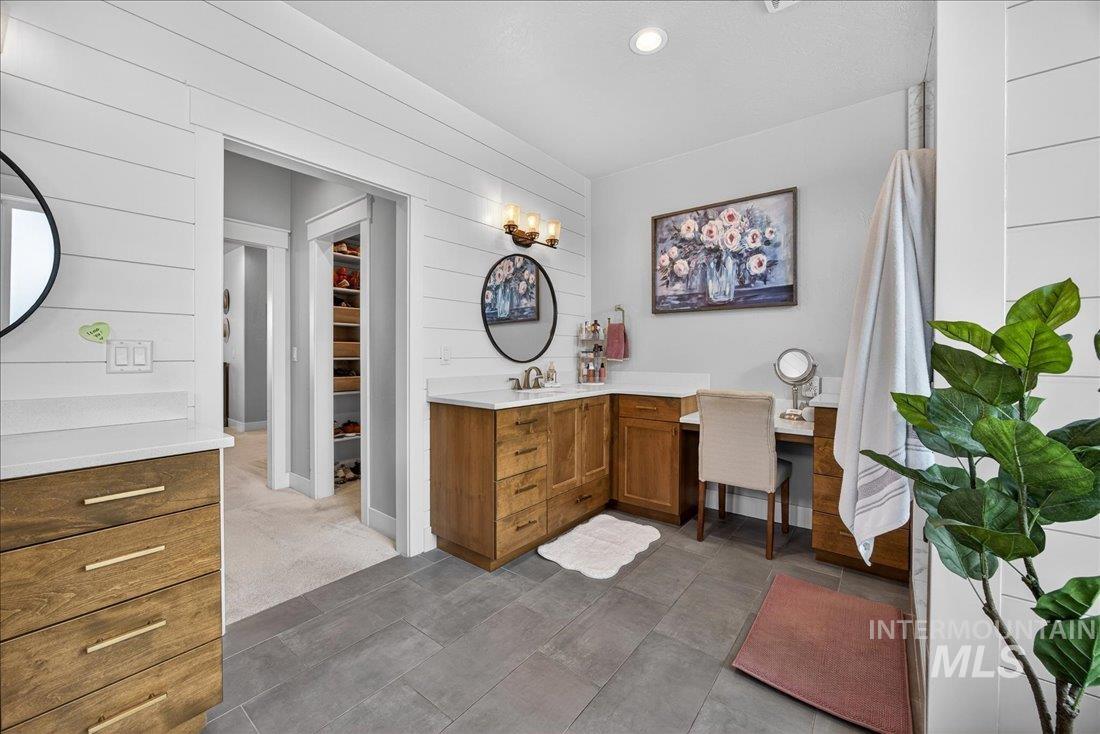 15111 Pinehurst Way Caldwell, ID 83607 - Photo 18 of 43 Full bath with vanity, a walk in closet, recessed lighting, and wooden walls
