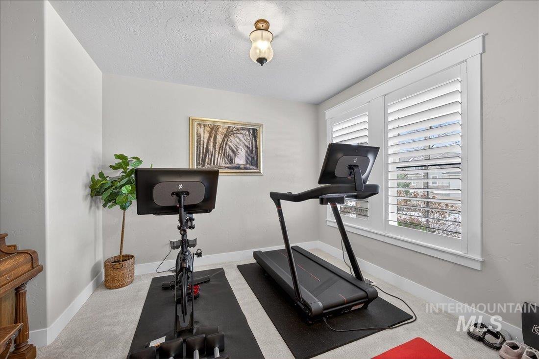 15111 Pinehurst Way Caldwell, ID 83607 - Photo 20 of 43 Workout area featuring carpet floors and a textured ceiling