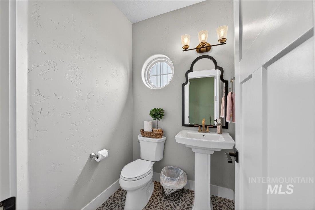 15111 Pinehurst Way Caldwell, ID 83607 - Photo 21 of 43 Half bathroom with toilet and baseboards