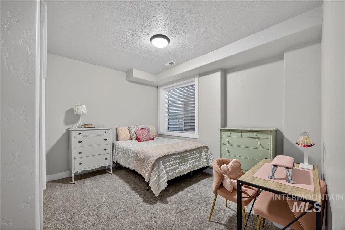 15111 Pinehurst Way Caldwell, ID 83607 - Photo 23 of 43 Bedroom with a textured ceiling and light carpet