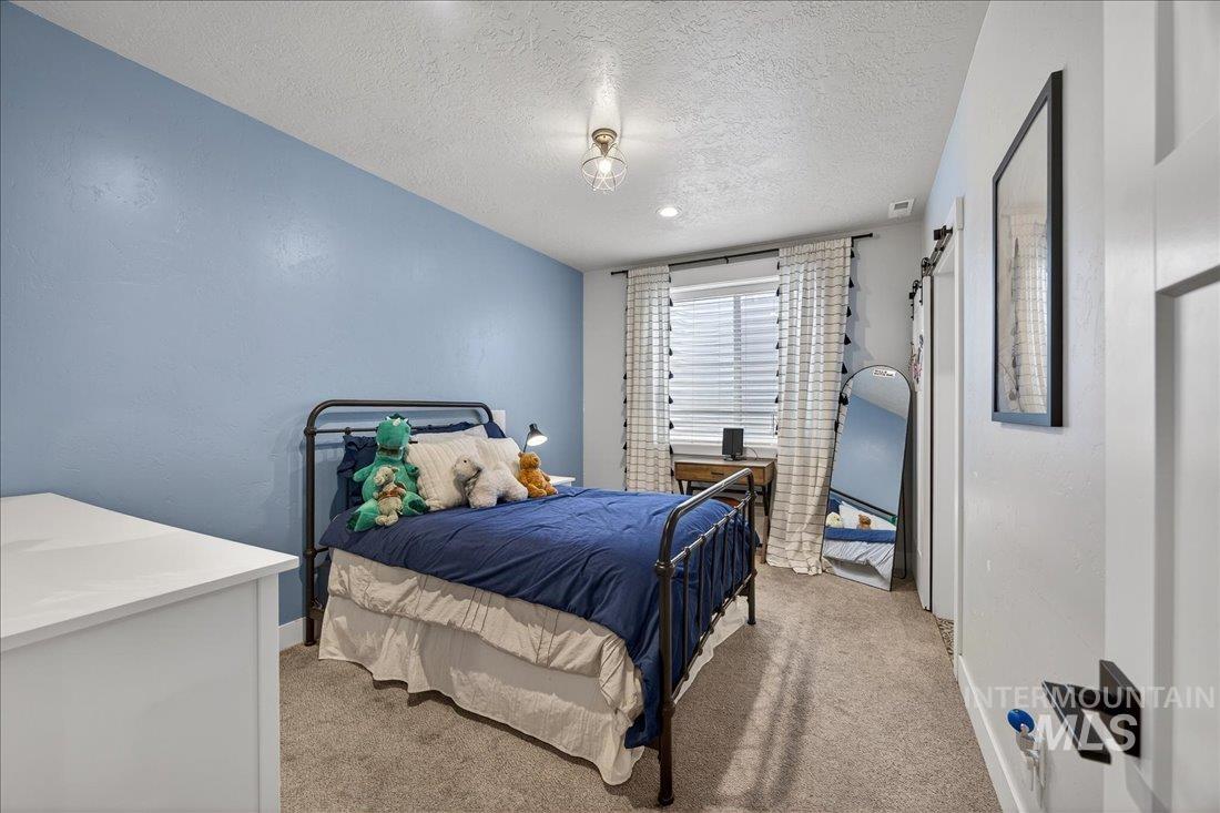 15111 Pinehurst Way Caldwell, ID 83607 - Photo 27 of 43 Bedroom with a textured ceiling and carpet flooring
