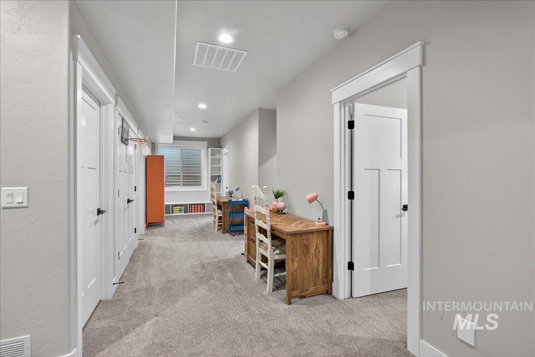 15111 Pinehurst Way Caldwell, ID 83607 - Photo 30 of 43 Hallway featuring light carpet, recessed lighting, and a textured wall