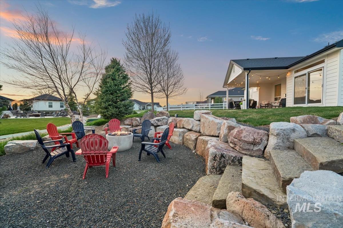 15111 Pinehurst Way Caldwell, ID 83607 - Photo 38 of 43 Patio terrace at dusk with a patio and a fire pit