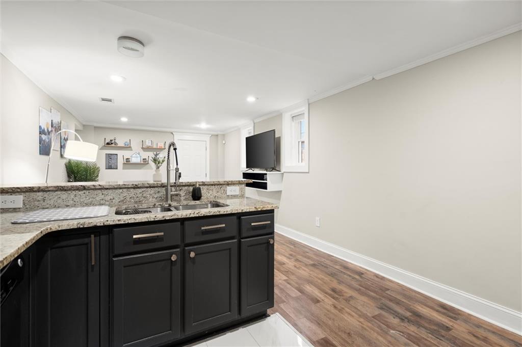 153 Randolph Street Northeast, Unit B Atlanta, GA 30312 - Photo 11 of 22 a kitchen with granite countertop a sink and cabinets