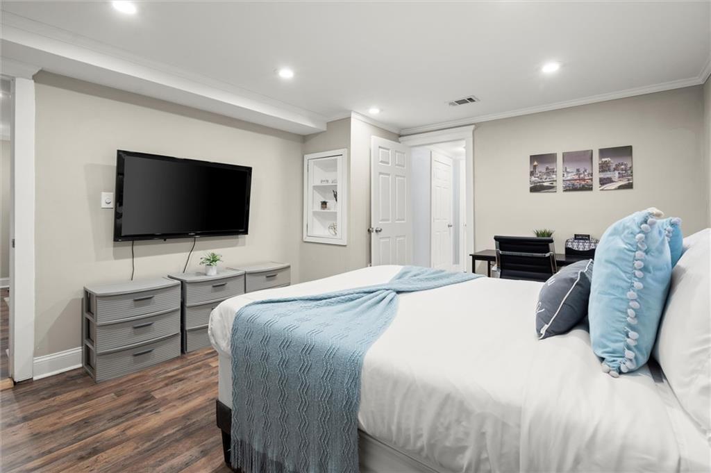 153 Randolph Street Northeast, Unit B Atlanta, GA 30312 - Photo 13 of 22 a bedroom with a bed and a flat screen tv