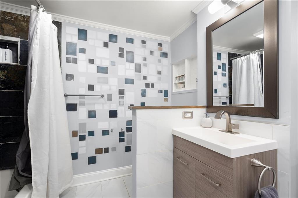 153 Randolph Street Northeast, Unit B Atlanta, GA 30312 - Photo 16 of 22 a bathroom with a sink a vanity and a mirror