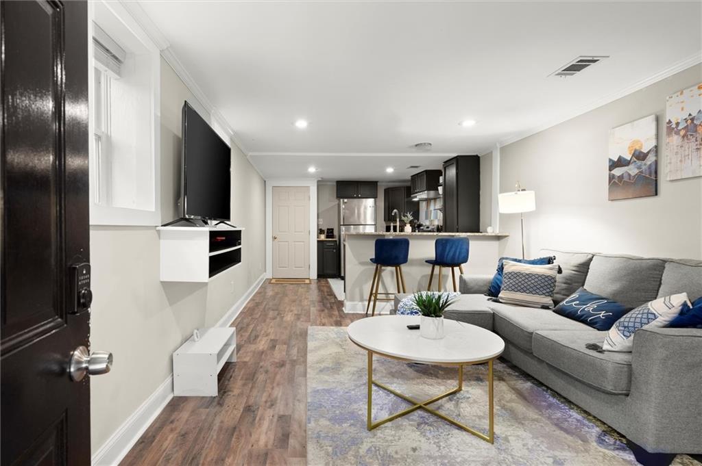 153 Randolph Street Northeast, Unit B Atlanta, GA 30312 - Photo 2 of 22 a living room with furniture and a kitchen view