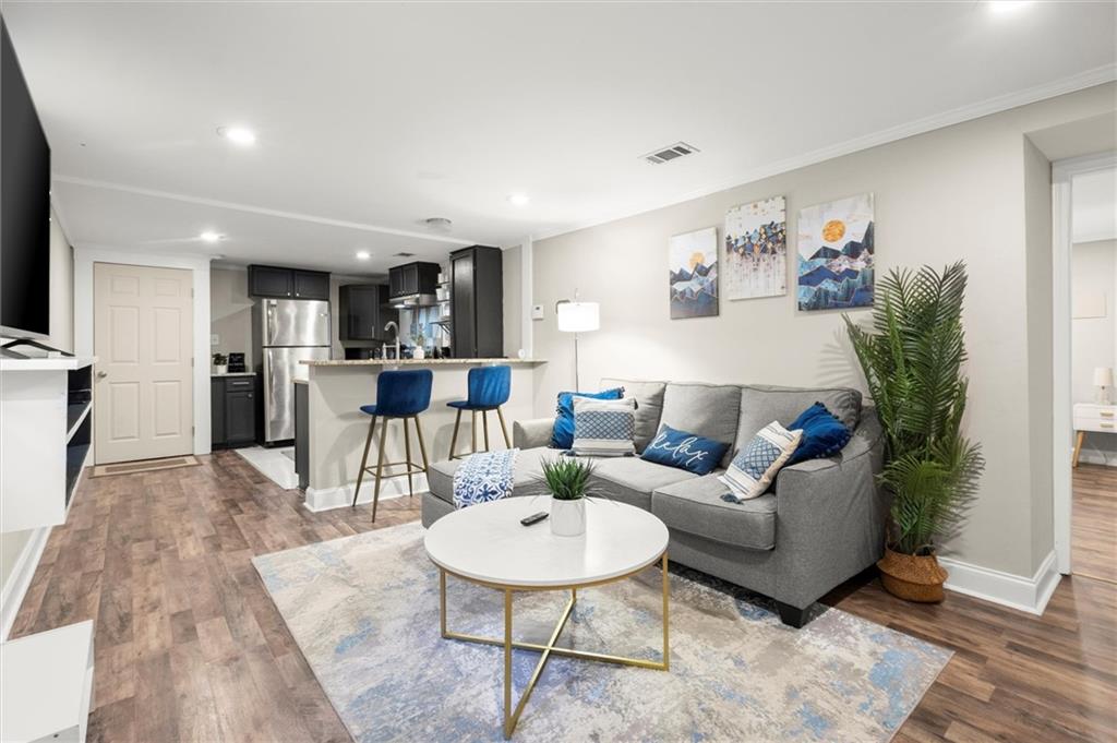 153 Randolph Street Northeast, Unit B Atlanta, GA 30312 - Photo 3 of 22 a living room with furniture and kitchen view