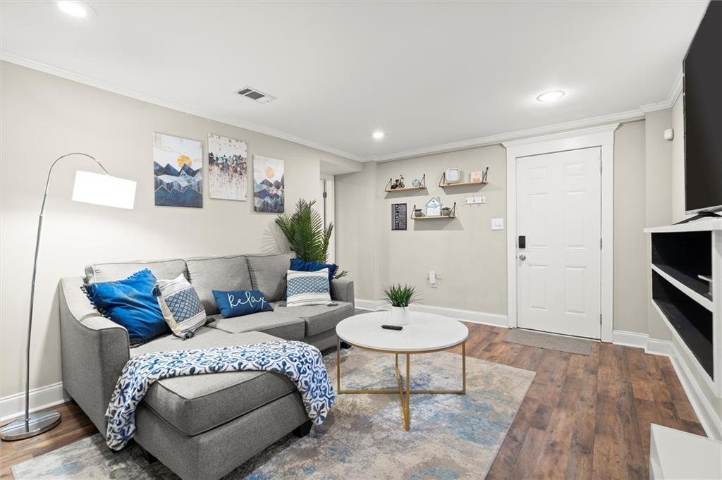 153 Randolph Street Northeast, Unit B Atlanta, GA 30312 - Photo 4 of 22 a living room with furniture and wooden floor