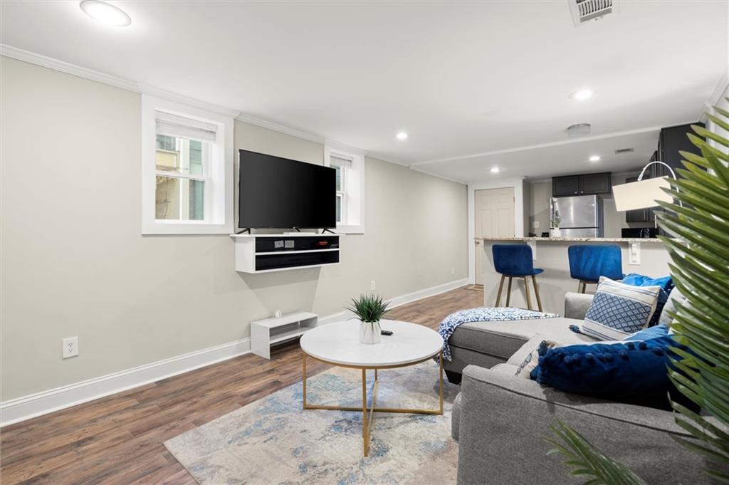 153 Randolph Street Northeast, Unit B Atlanta, GA 30312 - Photo 5 of 22 a living room with furniture a flat screen tv and a dining table