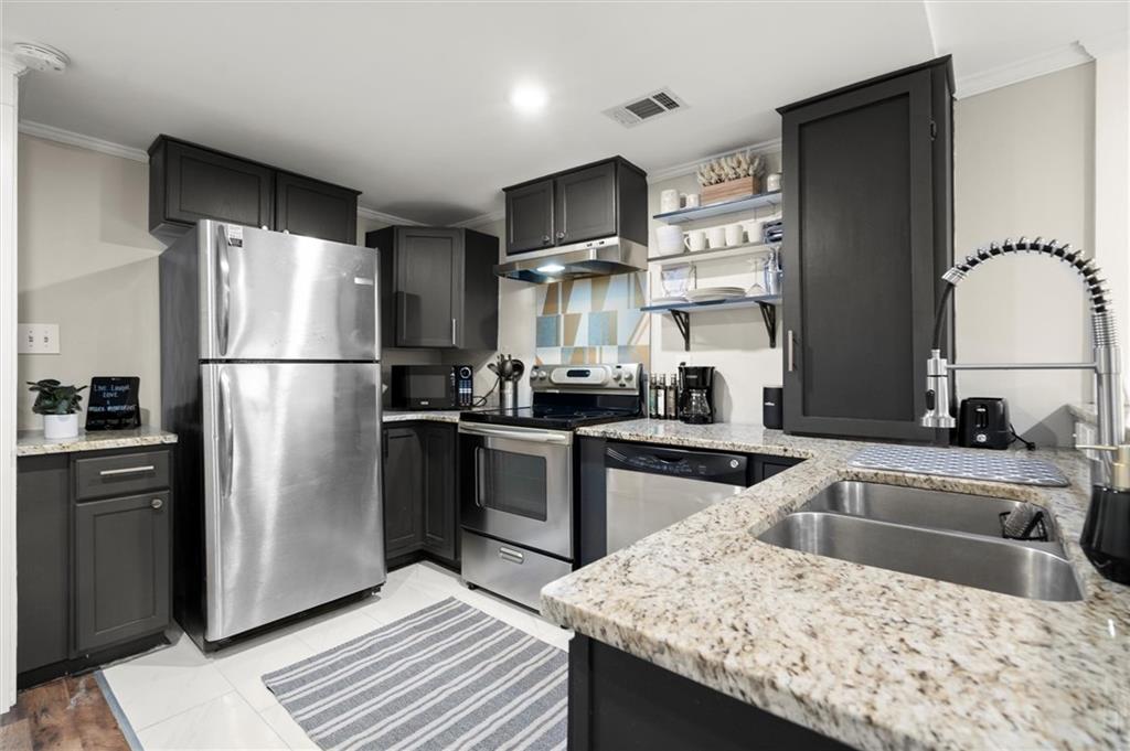 153 Randolph Street Northeast, Unit B Atlanta, GA 30312 - Photo 9 of 22 a kitchen with granite countertop a refrigerator stove and sink