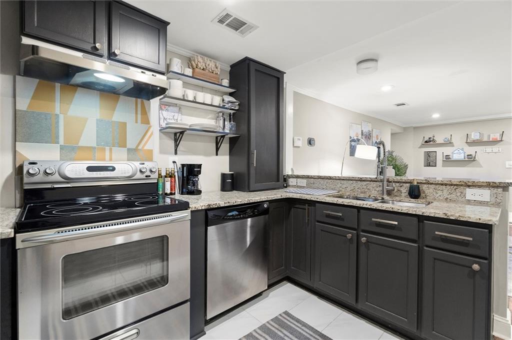 153 Randolph Street Northeast, Unit B Atlanta, GA 30312 - Photo 10 of 22 a kitchen with stainless steel appliances granite countertop a stove and a sink