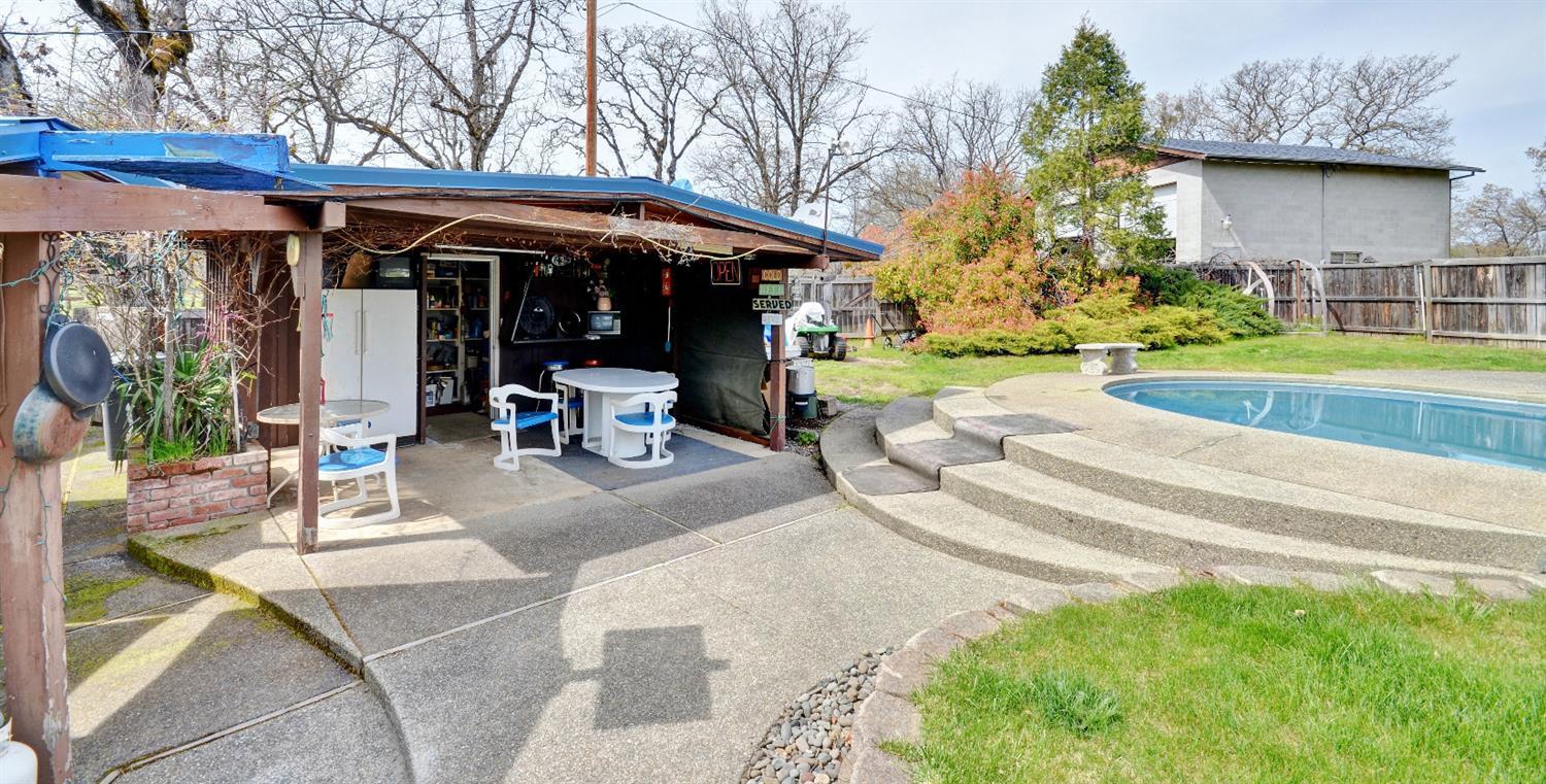 11610 Duggan Road White City, OR 97503 - Photo 21 of 28 a view of a patio with a table and chairs under an umbrella