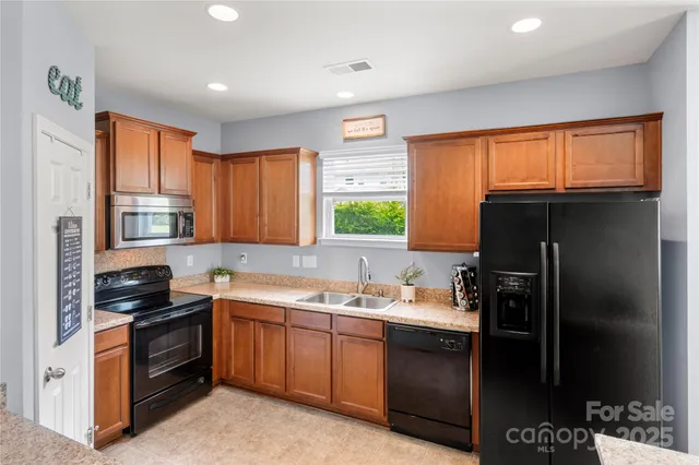 a kitchen with a sink stove and refrigerator