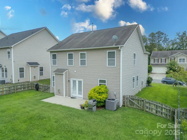 a front view of a house with a garden and plants