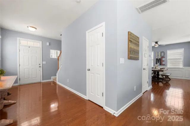 a view of a livingroom with furniture and hardwood floor