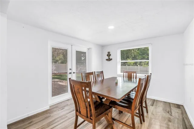 a view of a dining room with furniture and wooden floor