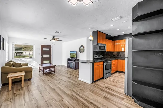 a living room with furniture and wooden floor