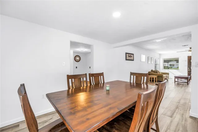 a dining room with furniture and wooden floor