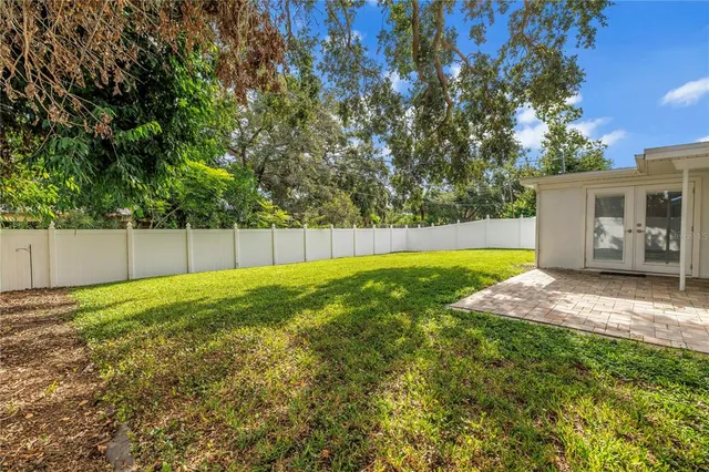 a view of a backyard with large trees