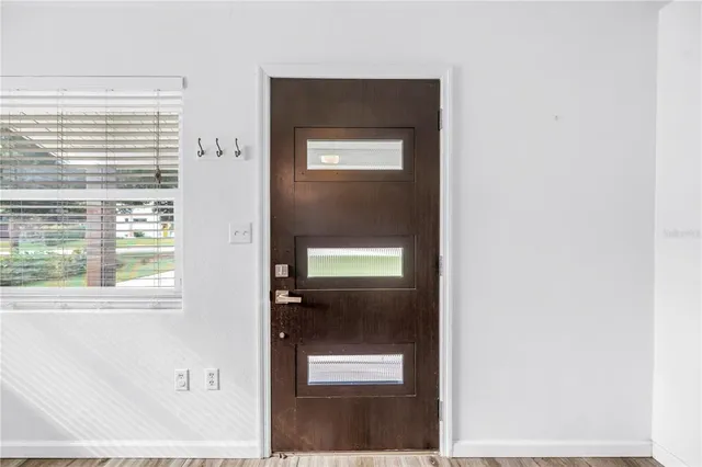 a view of a hallway with a front door