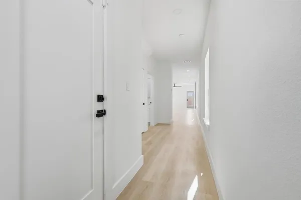 a view of hallway with wooden floor