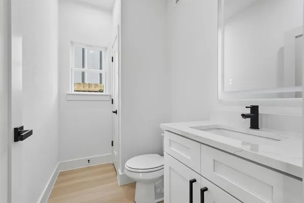 a bathroom with a sink toilet and vanity