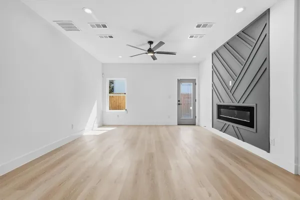 wooden floor in an empty room with a fireplace