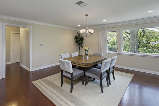 918 Lee Road Northbrook, IL 60062 - Photo 7 of 17 a dining room with furniture wooden floor and a chandelier