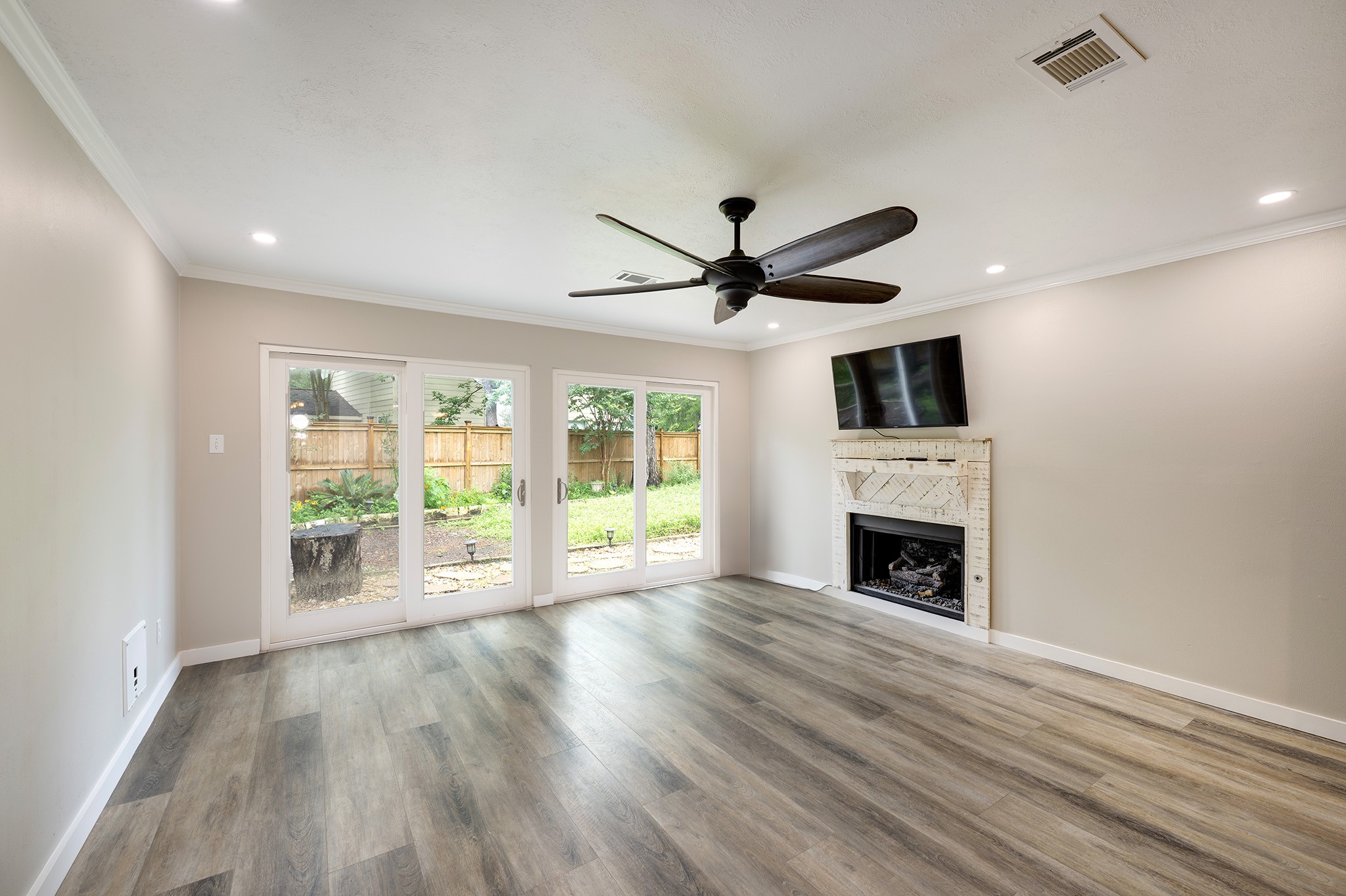 1911 North Red Cedar Circle Spring, TX 77380 - Photo 4 of 14 a view of an empty room with wooden floor and a window