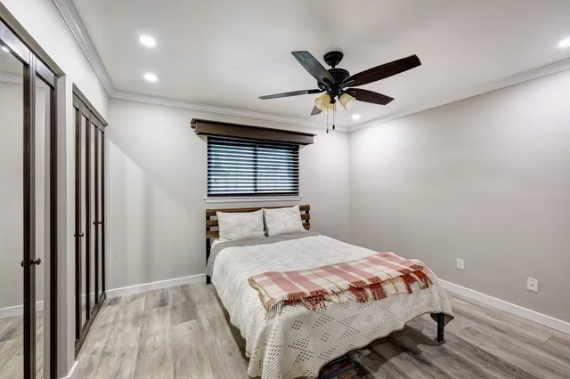 a bedroom with a large bed and a chandelier