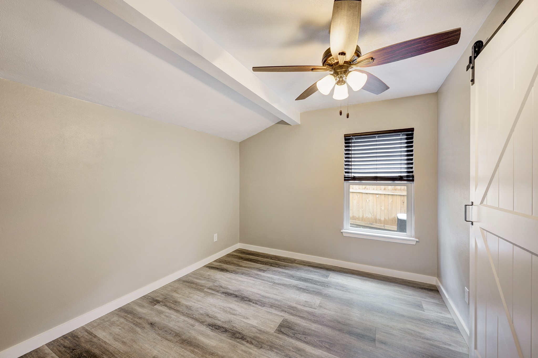 1911 North Red Cedar Circle Spring, TX 77380 - Photo 8 of 14 an empty room with a window and a fan
