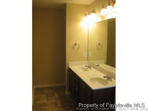 89 Jamestown Drive Spring Lake, NC 28390 - Photo 10 of 13 a bathroom with a sink and a mirror