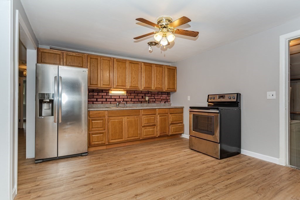 35 Bernadette Street Fitchburg, MA 01420 - Photo 3 of 19 a kitchen with stainless steel appliances a stove a refrigerator and a sink