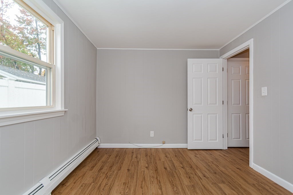 35 Bernadette Street Fitchburg, MA 01420 - Photo 5 of 19 a view of an empty room with wooden floor and a window