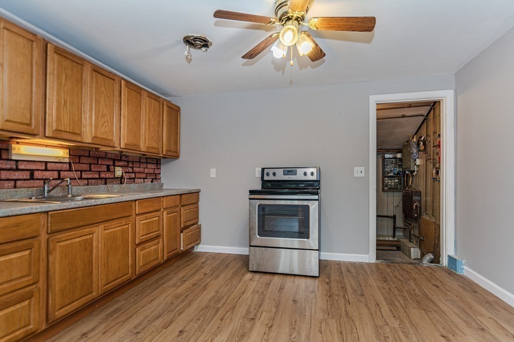 35 Bernadette Street Fitchburg, MA 01420 - Photo 8 of 19 a kitchen with stainless steel appliances a stove cabinets and wooden floor