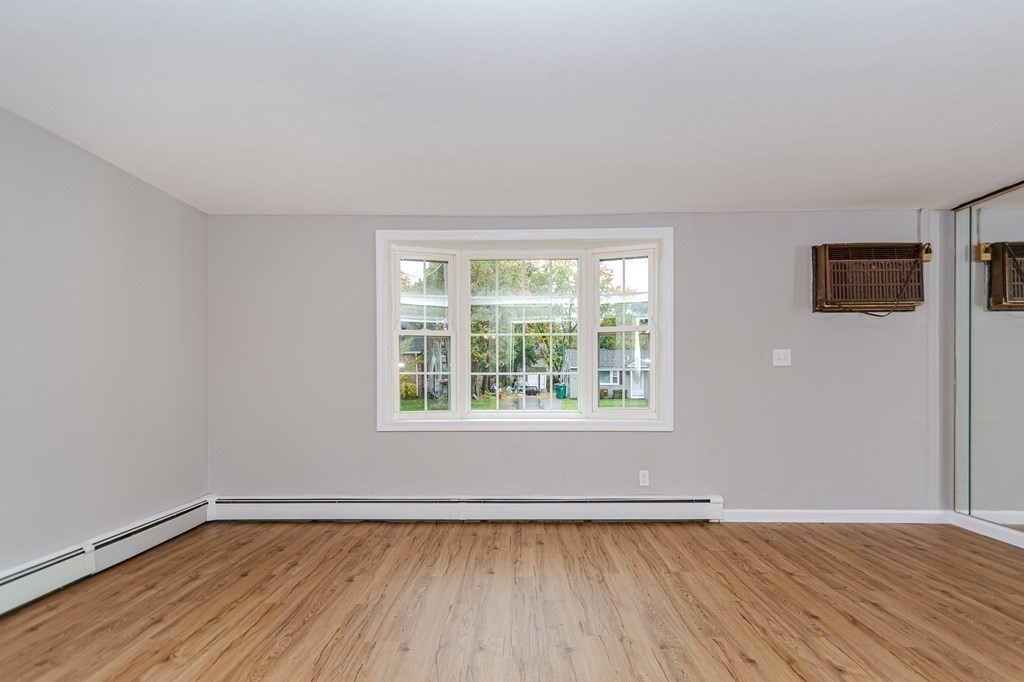 35 Bernadette Street Fitchburg, MA 01420 - Photo 9 of 19 a view of an empty room with wooden floor and a window