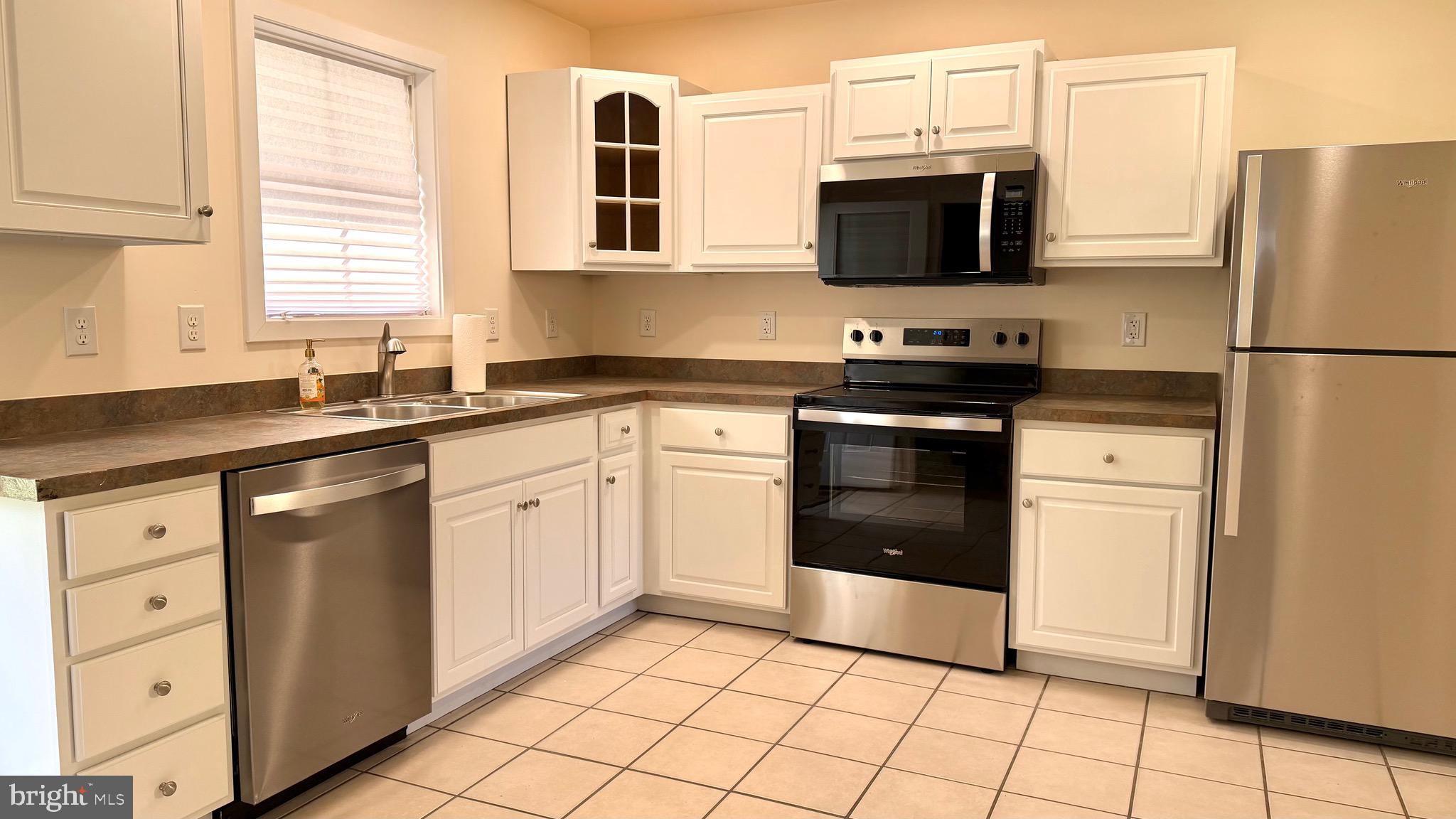 2697 Choptank Main Street Preston, MD 21655 - Photo 20 of 37 a kitchen with stainless steel appliances granite countertop a stove a sink and a microwave