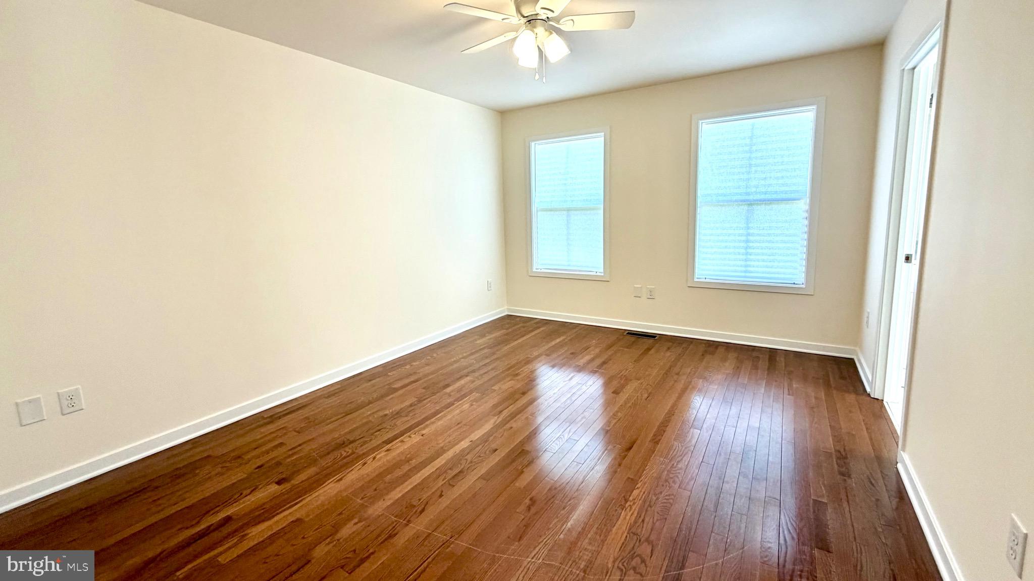 2697 Choptank Main Street Preston, MD 21655 - Photo 22 of 37 an empty room with wooden floor and windows
