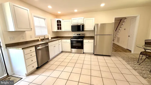 a bedroom with a bed and a flat tv screen next to a window