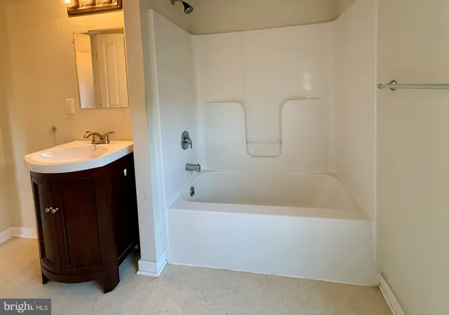 a bathroom with a sink a bathtub and a shower