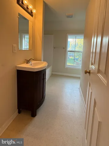 a room with a sink and a mirror