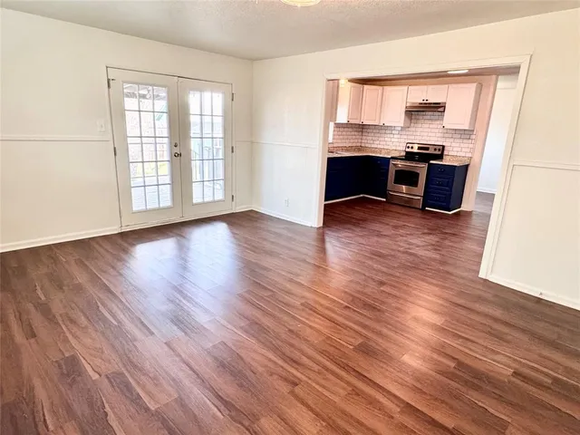 a view of a workspace with wooden floor and a window