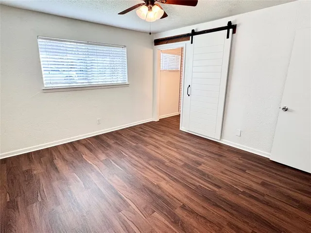 a view of a room with wooden floor and white walls