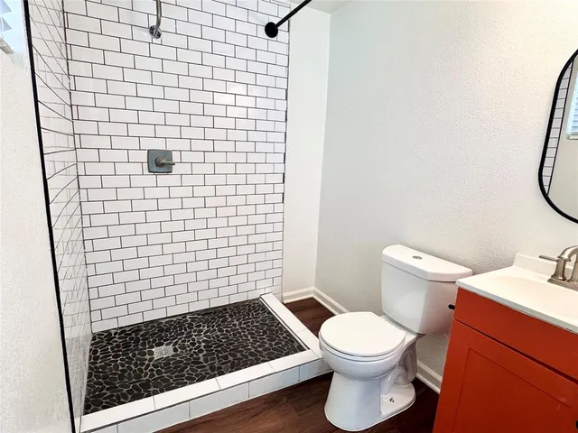 a bathroom with a toilet and a shower